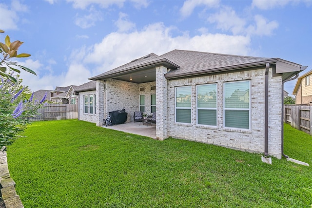 1939 Heather Canyon Dr, Pearland, TX 77089 - rear view of property with a fenced backyard, a patio, brick siding, and a shingled roof