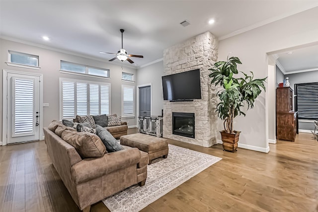 1939 Heather Canyon Dr, Pearland, TX 77089 - living area featuring ceiling fan, ornamental molding, wood finished floors, a fireplace, and recessed lighting