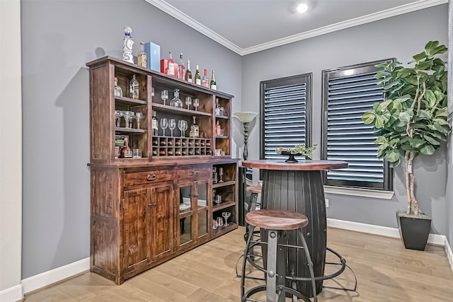 1939 Heather Canyon Dr, Pearland, TX 77089 - bar with ornamental molding and light wood finished floors