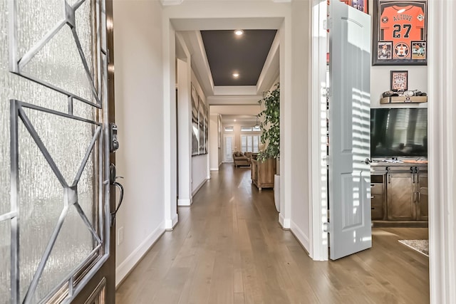1939 Heather Canyon Dr, Pearland, TX 77089 - hallway featuring wood finished floors, ornamental molding, and a raised ceiling