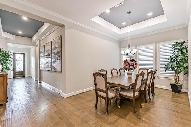 1939 Heather Canyon Dr, Pearland, TX 77089 - dining room with plenty of natural light, a tray ceiling, light wood finished floors, a chandelier, and recessed lighting