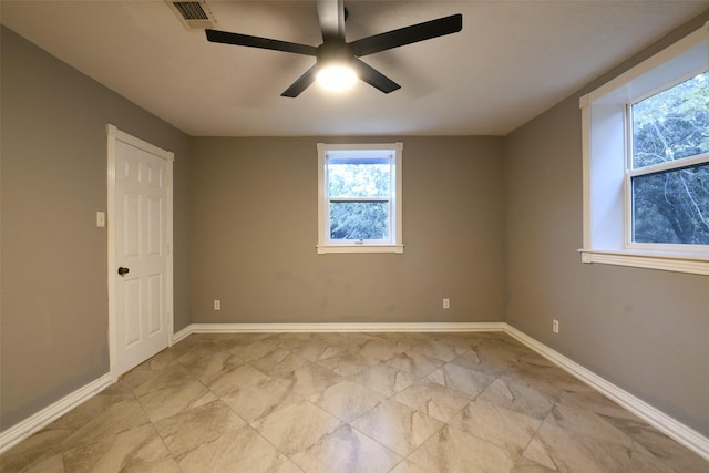 6709 Jay Rd, Hitchcock, TX 77563 - empty room featuring healthy amount of natural light, ceiling fan, and light marble finish flooring