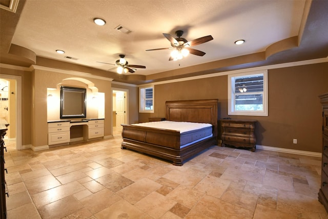 6709 Jay Rd, Hitchcock, TX 77563 - bedroom with stone tile flooring, built in desk, ornamental molding, a tray ceiling, and a ceiling fan
