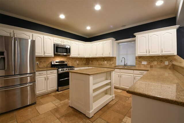 6709 Jay Rd, Hitchcock, TX 77563 - kitchen featuring appliances with stainless steel finishes, stone tile floors, white cabinetry, crown molding, and decorative backsplash