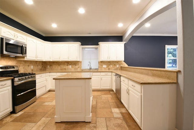 6709 Jay Rd, Hitchcock, TX 77563 - kitchen featuring stainless steel appliances, stone tile floors, ornamental molding, decorative backsplash, and recessed lighting
