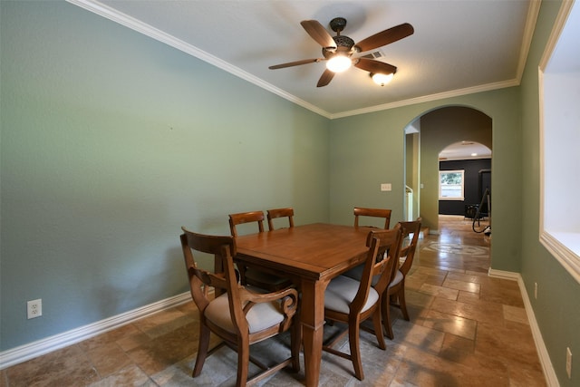 6709 Jay Rd, Hitchcock, TX 77563 - dining space with arched walkways, stone tile flooring, ceiling fan, and crown molding