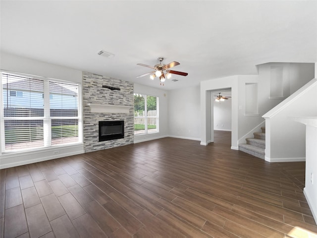 2317 Shady Pine Dr, Conroe, TX 77301 - unfurnished living room featuring ceiling fan, stairs, dark wood finished floors, and a large fireplace