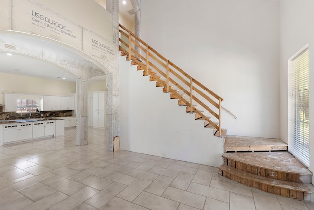 2464 N Walker Rd, Cleveland, TX 77328 - stairway with arched walkways and a high ceiling