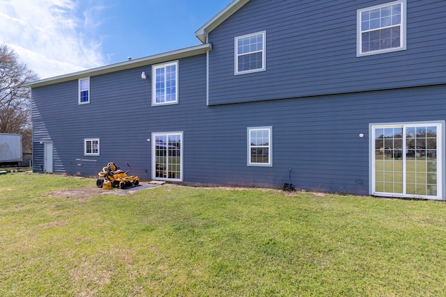 2464 N Walker Rd, Cleveland, TX 77328 - rear view of property featuring a lawn