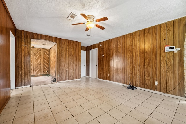 11302 Murr Way, Houston, TX 77048 - unfurnished room with wooden walls, ceiling fan, and a textured ceiling