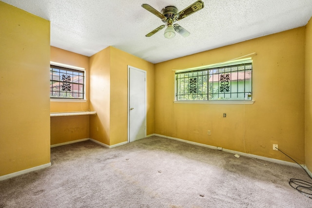 11302 Murr Way, Houston, TX 77048 - empty room with a textured ceiling, a ceiling fan, and carpet flooring