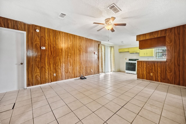 11302 Murr Way, Houston, TX 77048 - unfurnished living room featuring a ceiling fan, wooden walls, and a textured ceiling