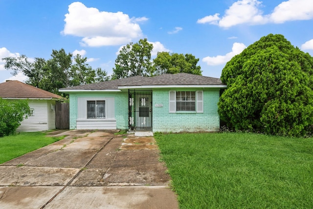 11302 Murr Way, Houston, TX 77048 - ranch-style house with a front yard, driveway, brick siding, and roof with shingles