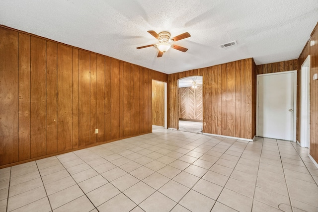 11302 Murr Way, Houston, TX 77048 - unfurnished room featuring ceiling fan, a textured ceiling, and wooden walls
