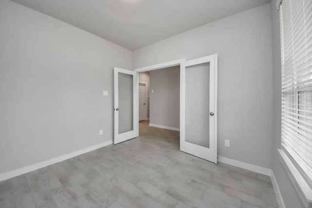 15819 Walnut Leaf Ln, Cypress, TX 77429 - empty room featuring french doors and light wood finished floors