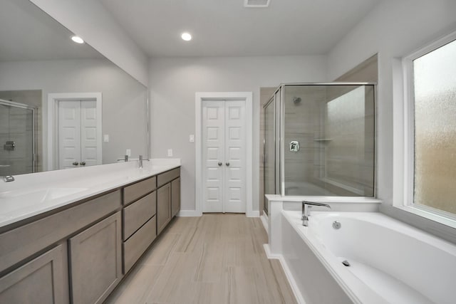 15819 Walnut Leaf Ln, Cypress, TX 77429 - full bath with a stall shower, a bath, double vanity, recessed lighting, and a closet