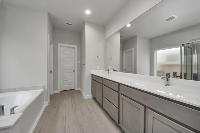 15819 Walnut Leaf Ln, Cypress, TX 77429 - full bath with double vanity, a garden tub, recessed lighting, and an enclosed shower