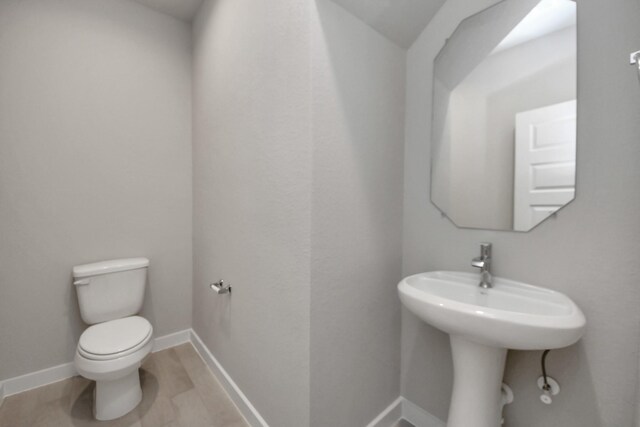 15819 Walnut Leaf Ln, Cypress, TX 77429 - half bathroom with toilet and baseboards