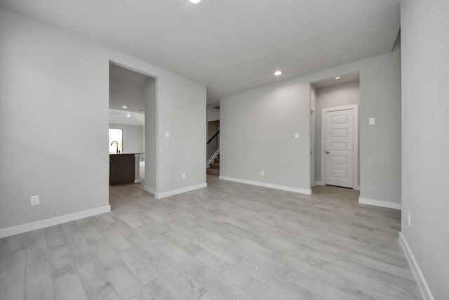 15819 Walnut Leaf Ln, Cypress, TX 77429 - unfurnished room with stairs, recessed lighting, and light wood-type flooring