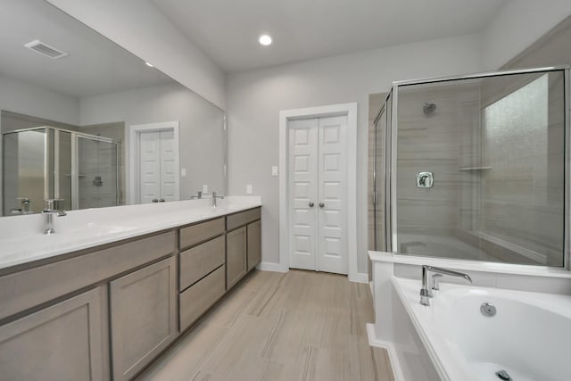 15819 Walnut Leaf Ln, Cypress, TX 77429 - full bathroom with a shower stall, a garden tub, double vanity, and recessed lighting