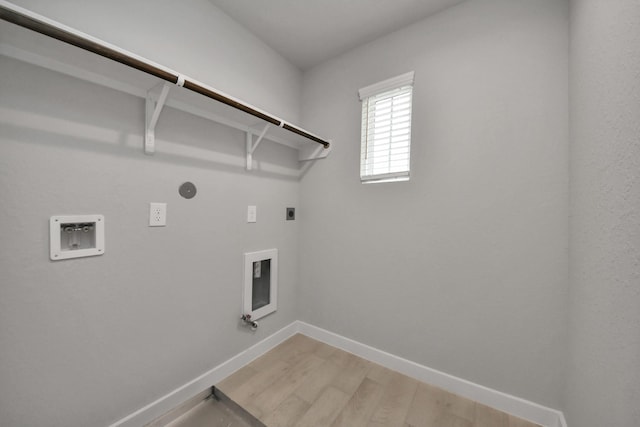 15819 Walnut Leaf Ln, Cypress, TX 77429 - laundry room featuring hookup for an electric dryer, washer hookup, hookup for a gas dryer, and light wood-type flooring