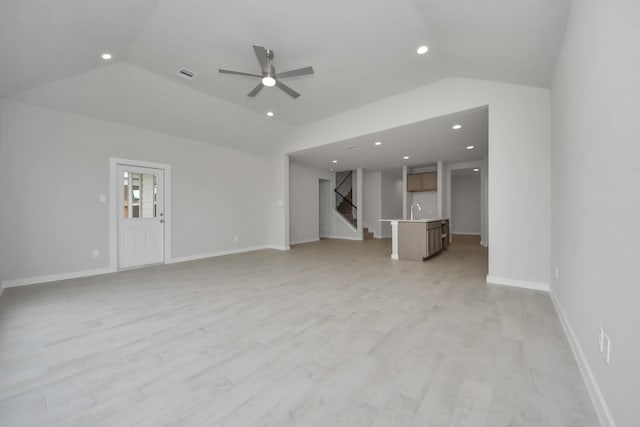 15819 Walnut Leaf Ln, Cypress, TX 77429 - unfurnished living room with lofted ceiling, ceiling fan, stairs, light wood finished floors, and recessed lighting