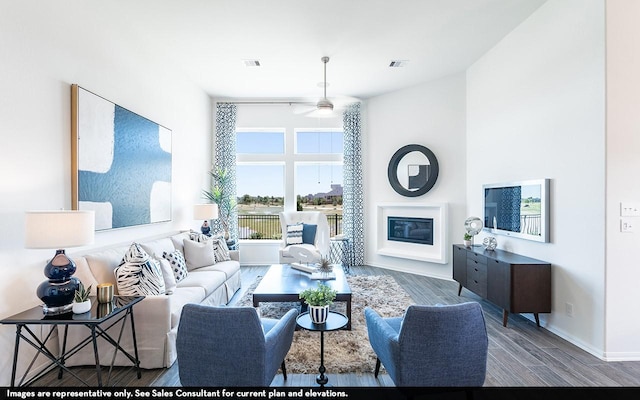 3911 Redbud Ct, Santa Fe, TX 77510 - living area featuring a glass covered fireplace, wood finished floors, and ceiling fan