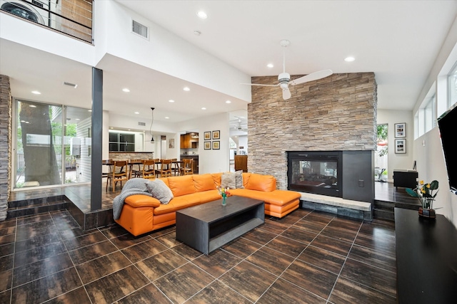 6532 Community Dr, West University Place, TX 77005 - living room featuring a stone fireplace, recessed lighting, and ceiling fan