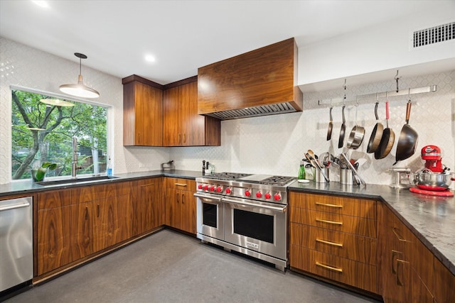 6532 Community Dr, West University Place, TX 77005 - kitchen featuring stainless steel appliances, brown cabinetry, decorative backsplash, dark countertops, and pendant lighting