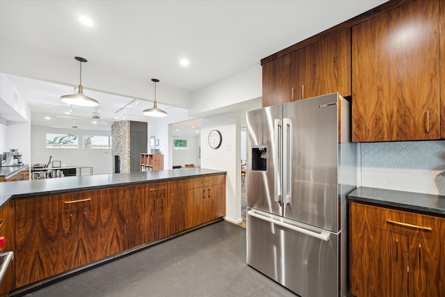 6532 Community Dr, West University Place, TX 77005 - kitchen with high end refrigerator, dark countertops, backsplash, decorative light fixtures, and recessed lighting