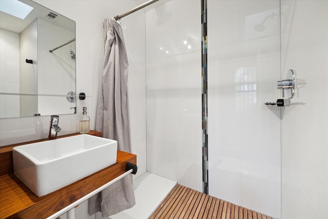 6532 Community Dr, West University Place, TX 77005 - bathroom featuring a walk in shower and a skylight