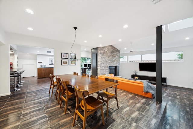 6532 Community Dr, West University Place, TX 77005 - dining space with a stone fireplace, recessed lighting, and a ceiling fan