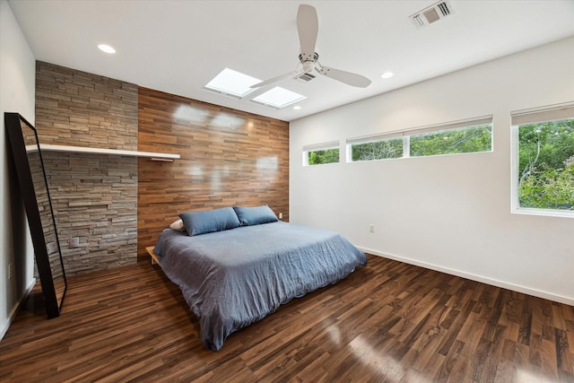 6532 Community Dr, West University Place, TX 77005 - bedroom featuring a skylight, wood finished floors, recessed lighting, and a ceiling fan