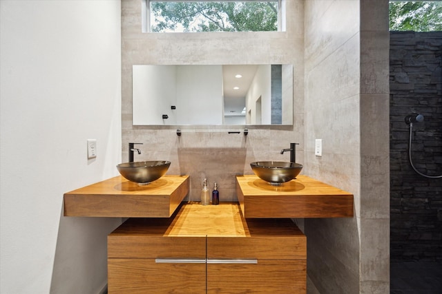 6532 Community Dr, West University Place, TX 77005 - full bathroom featuring backsplash, double vanity, and tiled shower