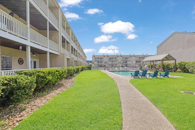 4747 Nasa Pkwy Unit 110, Seabrook, TX 77586 - view of green lawn featuring a gazebo, ceiling fan, a community pool, and a balcony