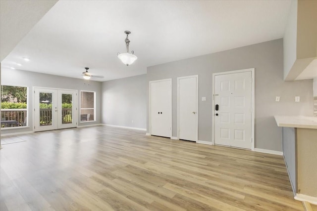 4747 Nasa Pkwy Unit 110, Seabrook, TX 77586 - unfurnished living room featuring light wood-type flooring, ceiling fan, and french doors