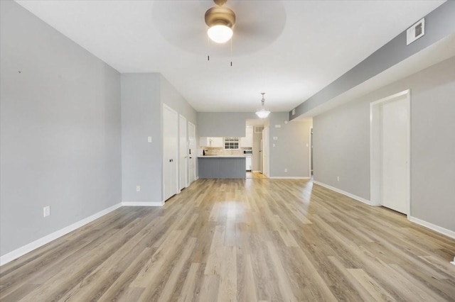 4747 Nasa Pkwy Unit 110, Seabrook, TX 77586 - unfurnished living room featuring a ceiling fan and light wood finished floors