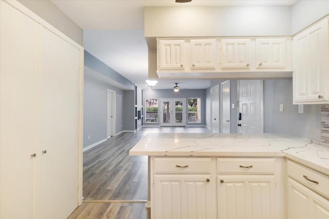 4747 Nasa Pkwy Unit 110, Seabrook, TX 77586 - kitchen with a peninsula, open floor plan, light wood-type flooring, and light stone countertops