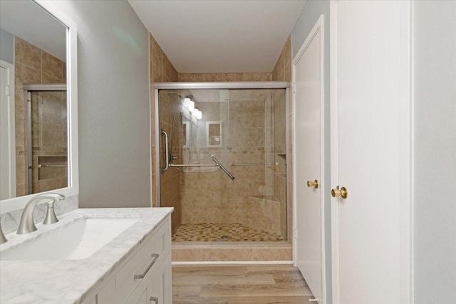 4747 Nasa Pkwy Unit 110, Seabrook, TX 77586 - bathroom featuring vanity, wood finished floors, and a shower stall
