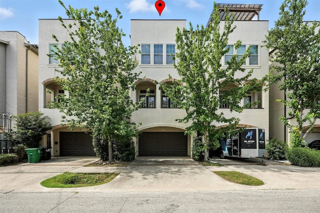 4106 Schuler St, Houston, TX 77007 - view of front of house with a garage, driveway, and stucco siding