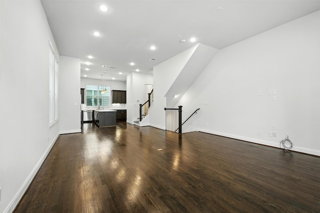 4106 Schuler St, Houston, TX 77007 - unfurnished living room with dark wood-style flooring, recessed lighting, and stairway