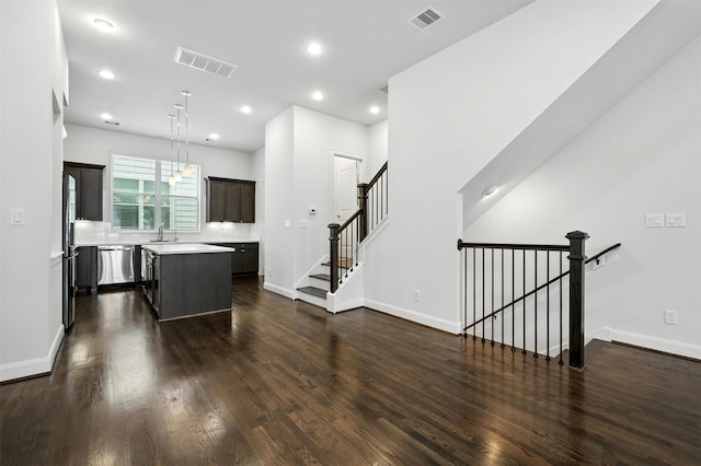 4106 Schuler St, Houston, TX 77007 - kitchen featuring stainless steel dishwasher, light countertops, a kitchen island, dark wood-style floors, and freestanding refrigerator