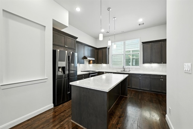 4106 Schuler St, Houston, TX 77007 - kitchen with appliances with stainless steel finishes, dark wood-type flooring, decorative backsplash, light countertops, and dark brown cabinetry