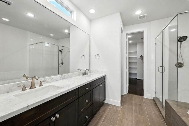 4106 Schuler St, Houston, TX 77007 - bathroom featuring a shower stall, double vanity, a walk in closet, and recessed lighting