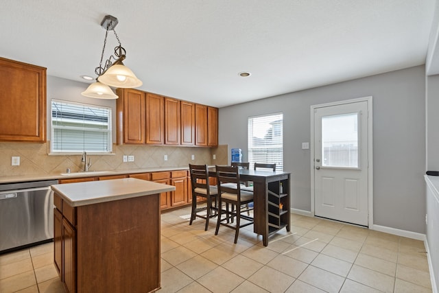 29406 Legends Stone Dr, Spring, TX 77386 - kitchen featuring dishwasher, light countertops, decorative backsplash, light tile patterned floors, and hanging light fixtures