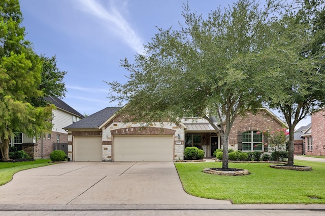 14107 Park Antique Ln, Cypress, TX 77429 - view of front of home featuring a garage, concrete driveway, a front lawn, and brick siding