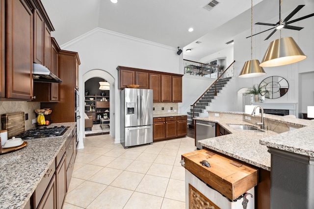 14107 Park Antique Ln, Cypress, TX 77429 - kitchen with stainless steel appliances, ceiling fan, high vaulted ceiling, light tile patterned floors, and under cabinet range hood