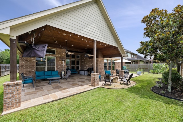 14107 Park Antique Ln, Cypress, TX 77429 - fenced backyard with a ceiling fan, an outdoor hangout area, and a patio