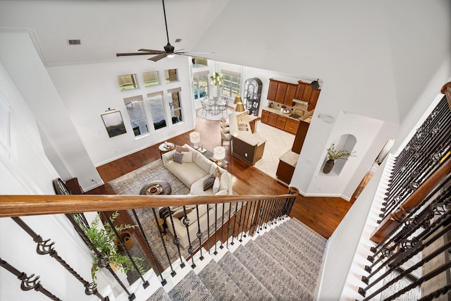 14107 Park Antique Ln, Cypress, TX 77429 - stairs featuring a towering ceiling, a ceiling fan, and wood finished floors