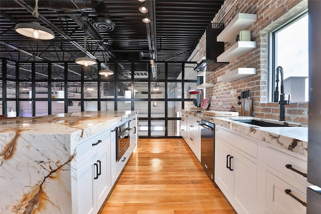 1435 Fm 1463rd Rd Unit C14, Katy, TX 77494 - kitchen with open shelves, oven, brick wall, dishwasher, and white cabinets